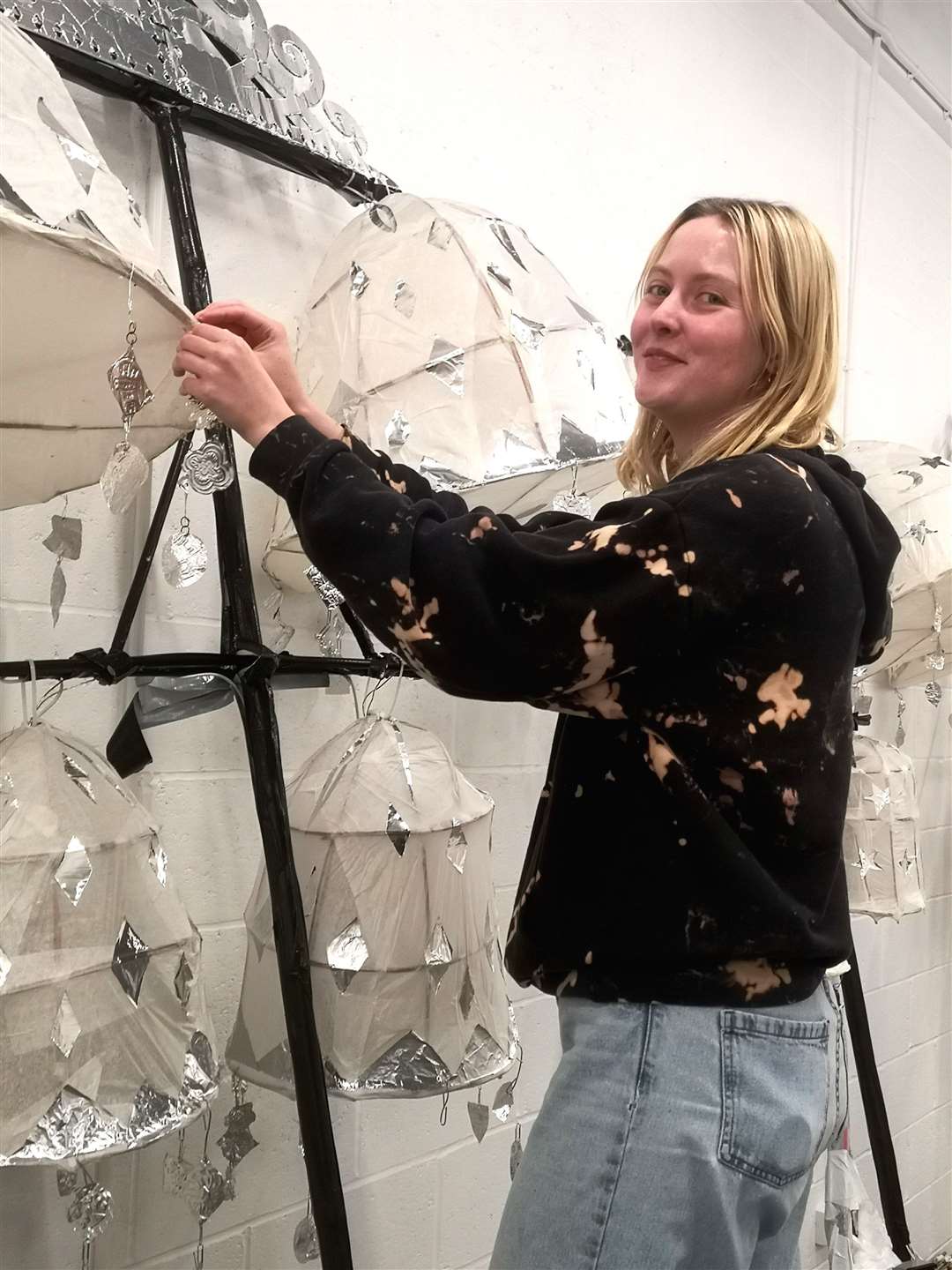 Amelia Johnson repairing lantern chandeliers in time for the parade. Picture: Future Foundry