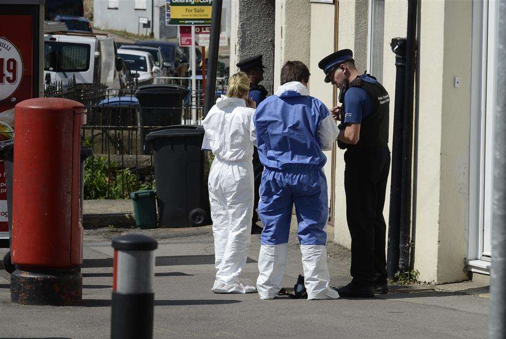 Forensics officers outside the flat in East Street, Tower Hamlets