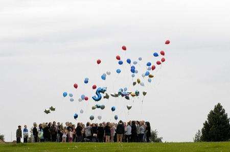 A group of youngsters who knew Kyle Coen releasing balloons in memory of him.