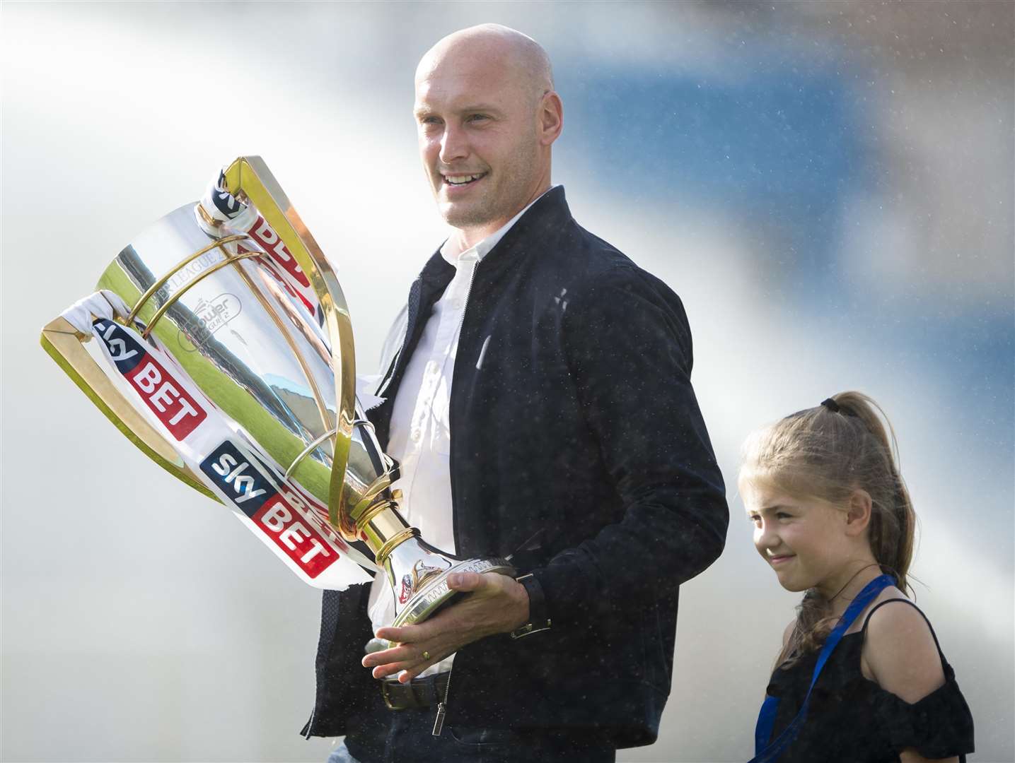 League 2 winning skipper Adam Barrett and his daughter were at Priestfield with the Championship trophy Picture: Ady Kerry