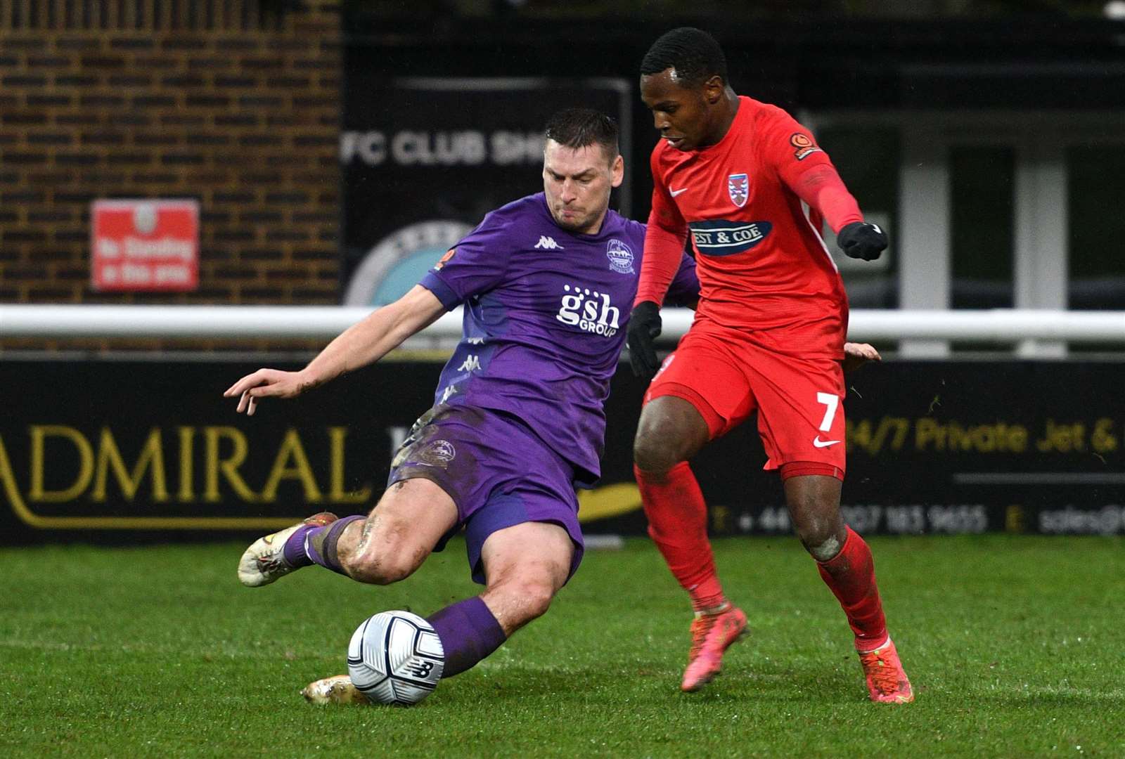 Dover defender Jake Goodman clears ahead of Dagenham's Josh Walker. Picture: Barry Goodwin (53955727)