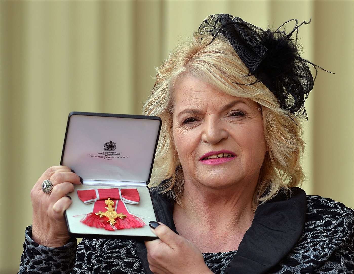 Sylvia Lancaster holds her OBE after it was presented to her by the Prince of Wales at an Investiture ceremony at Buckingham Palace in London in 2014 (Archive/PA)