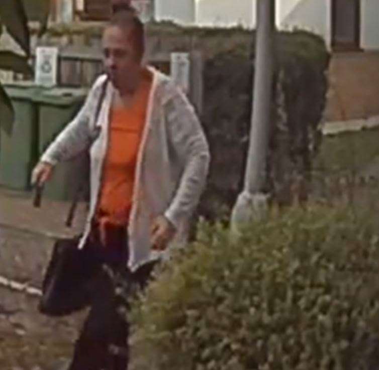 Kathleen Perry walking away from one of her victim's addresses in Maidstone wearing the clothes that was found at her address when police arrested her (60797711)