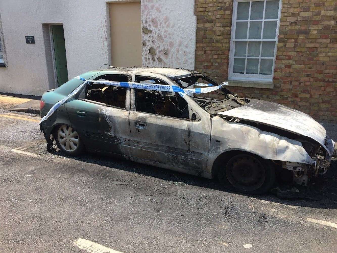 A burnt-out car in Church Street