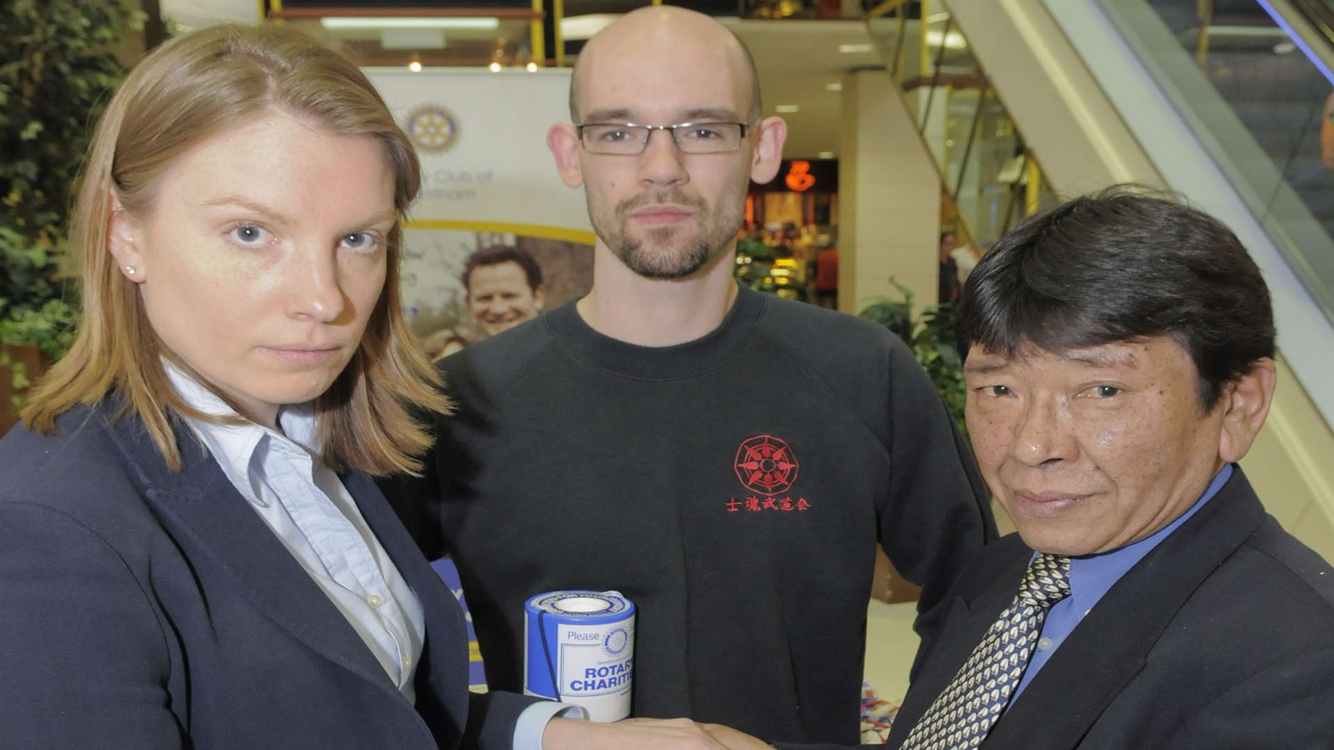 Tracey Crouch MP signs the Friendship Book held by Cllr Tashi Bhutia and watched by Adam Lawrie