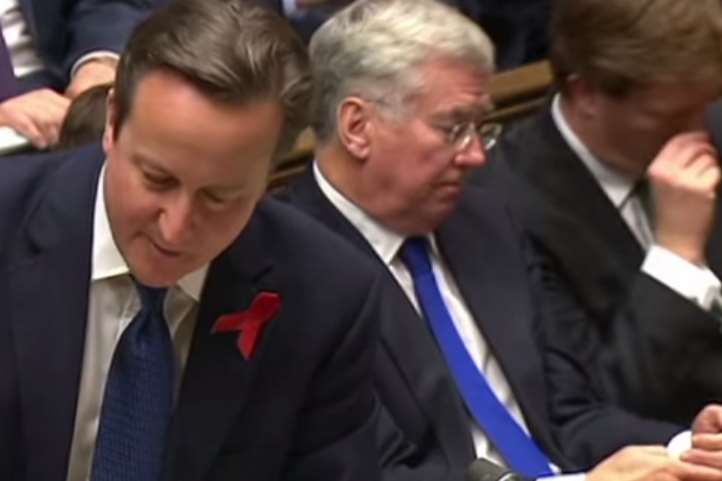 Mr Fallon checks his phone while Mr Cameron speaks