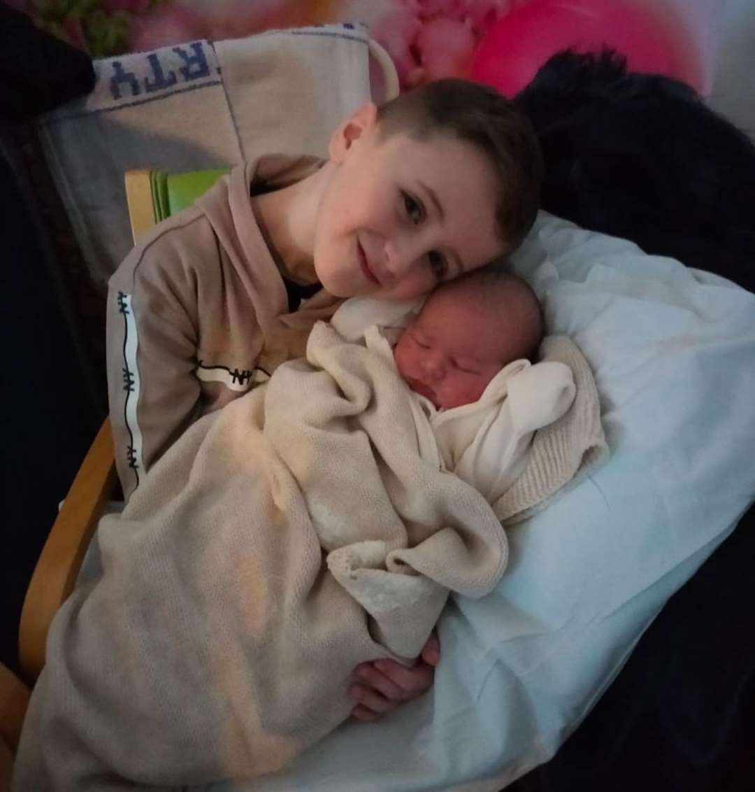 Alfie Terry, born on Christmas Day at Medway Maritime Hospital, in the arms of his older brother Archie