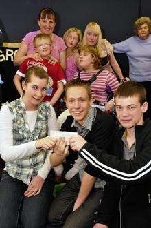 Centre front, from left Shannon Eastoe, 14, and Daniel Read, 15, hand over the cheque to Nathan Charles, 14.