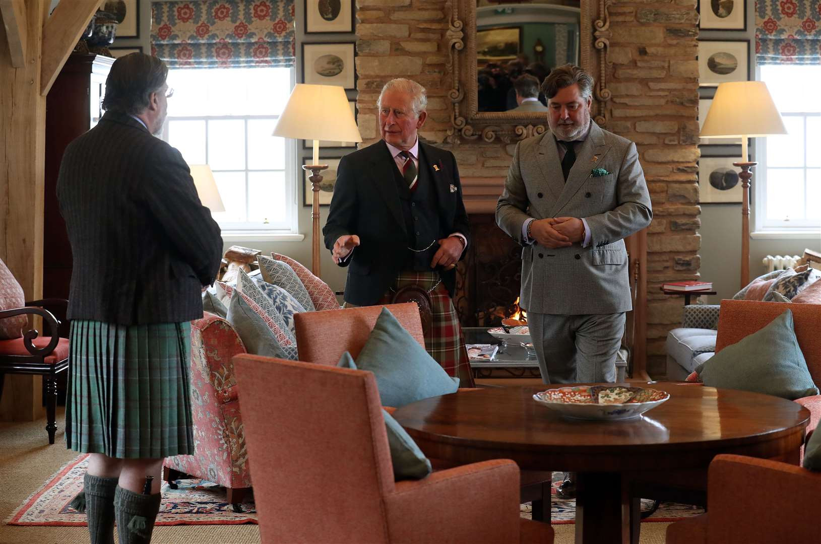 The then-Prince of Wales (centre) with Michael Fawcett (right) in 2019 (Andrew Milligan/PA)