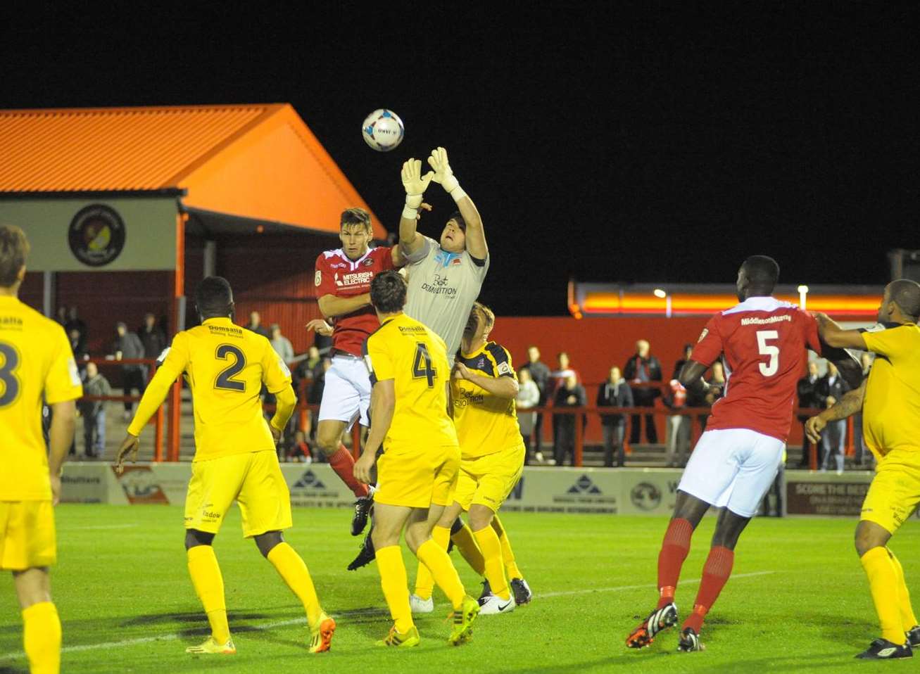 Charlie Sheringham challenges Eastbourne goalkeeper Lewis Carey Picture: Steve Crispe