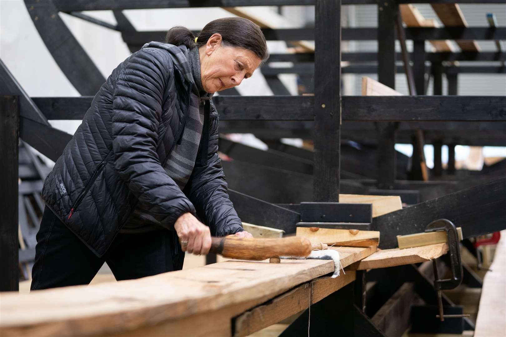 Angela Care Evans hammers in a trenail to join the first two parts of the keel (Joe Giddens/PA)