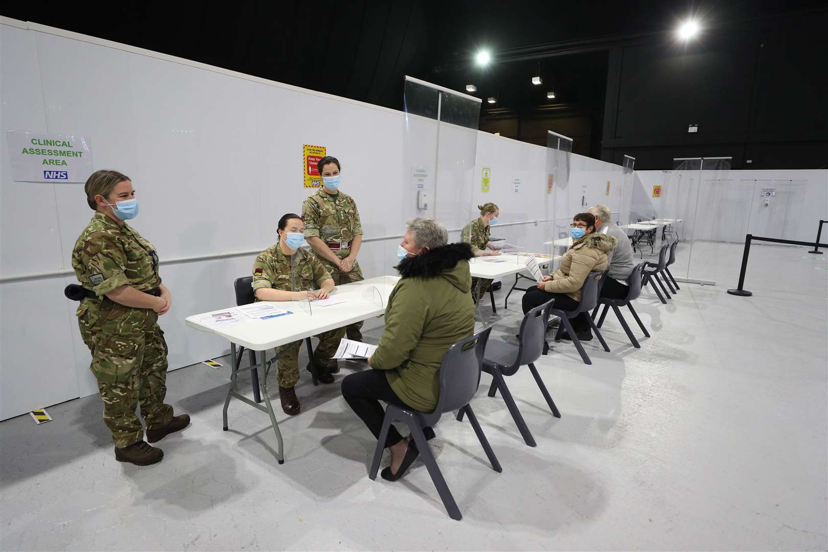 Military personnel speak with Joanne McLaren (centre) as she arrives for a clinic at the Winter Gardens (Peter Byrne/PA)