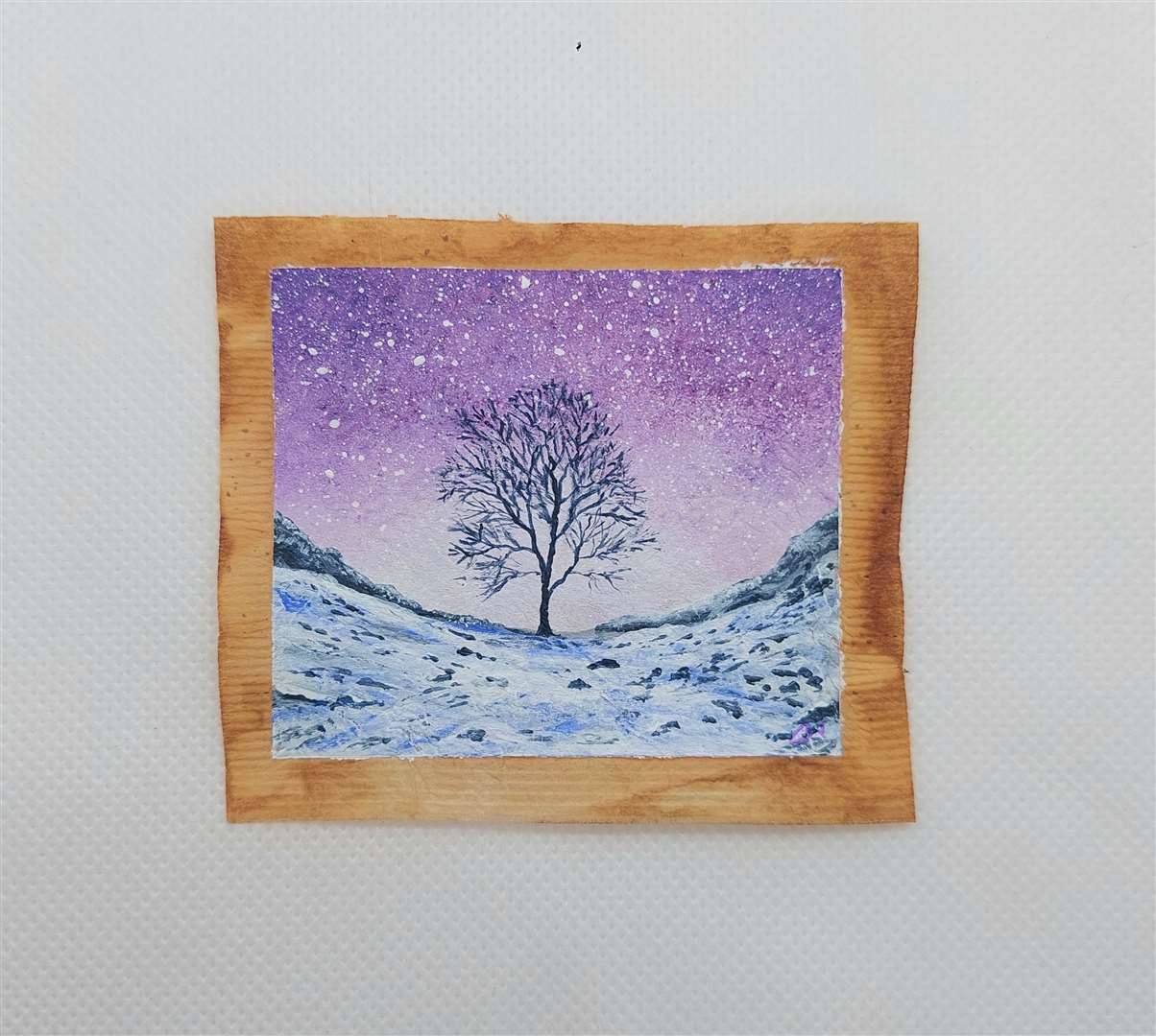 The Sycamore Gap tree painted in winter on a used tea bag (Caroline West/PA)