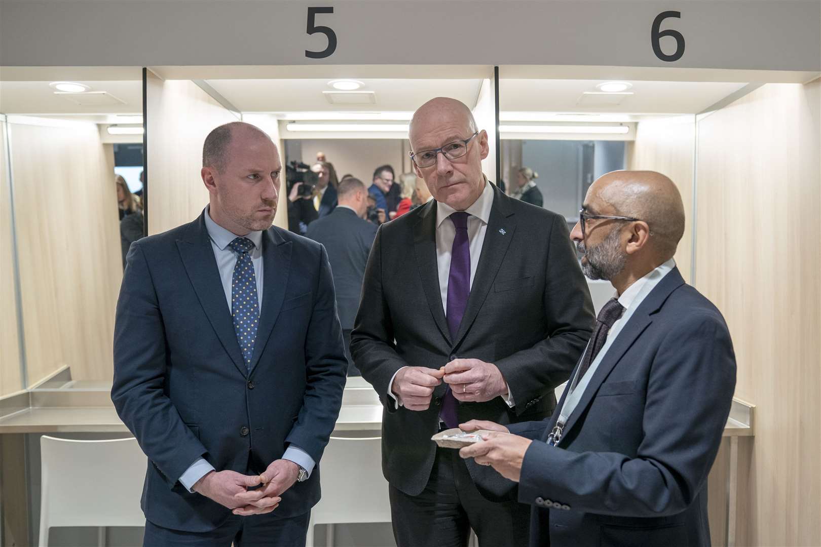 First Minister John Swinney, centre, and Health Secretary Neil Gray, left, with Dr Saket Priyadarshi at the centre (Jane Barlow/PA)