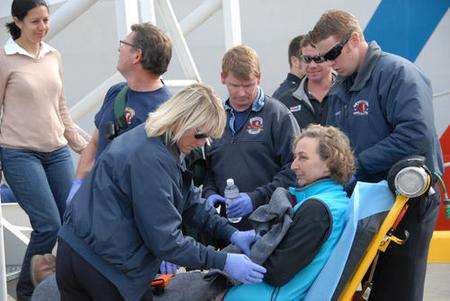 Jane Hitchens reaches land after being rescued by the US Coast Guard after a two-day rescue operation. Picture: US Coast Guard fireman Jordan Akiyama