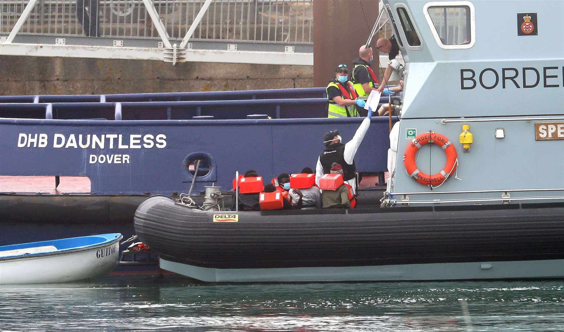 A group of people thought to be migrants are taken into Dover on board a Border Force boat (Gareth Fuller/PA)