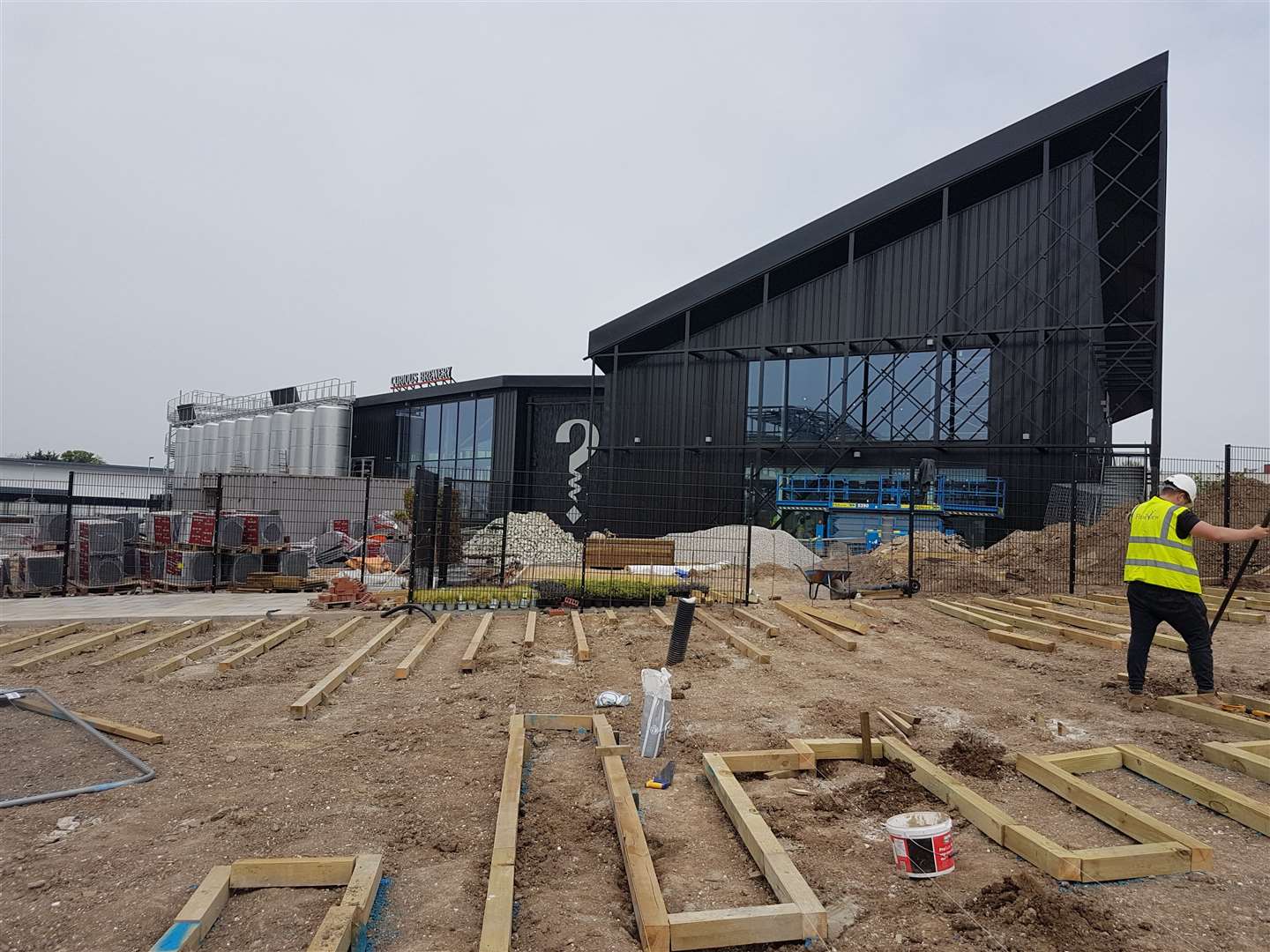 Construction teams are still working on the Curious Brewery's landscaping and can also be seen working on the building's rear