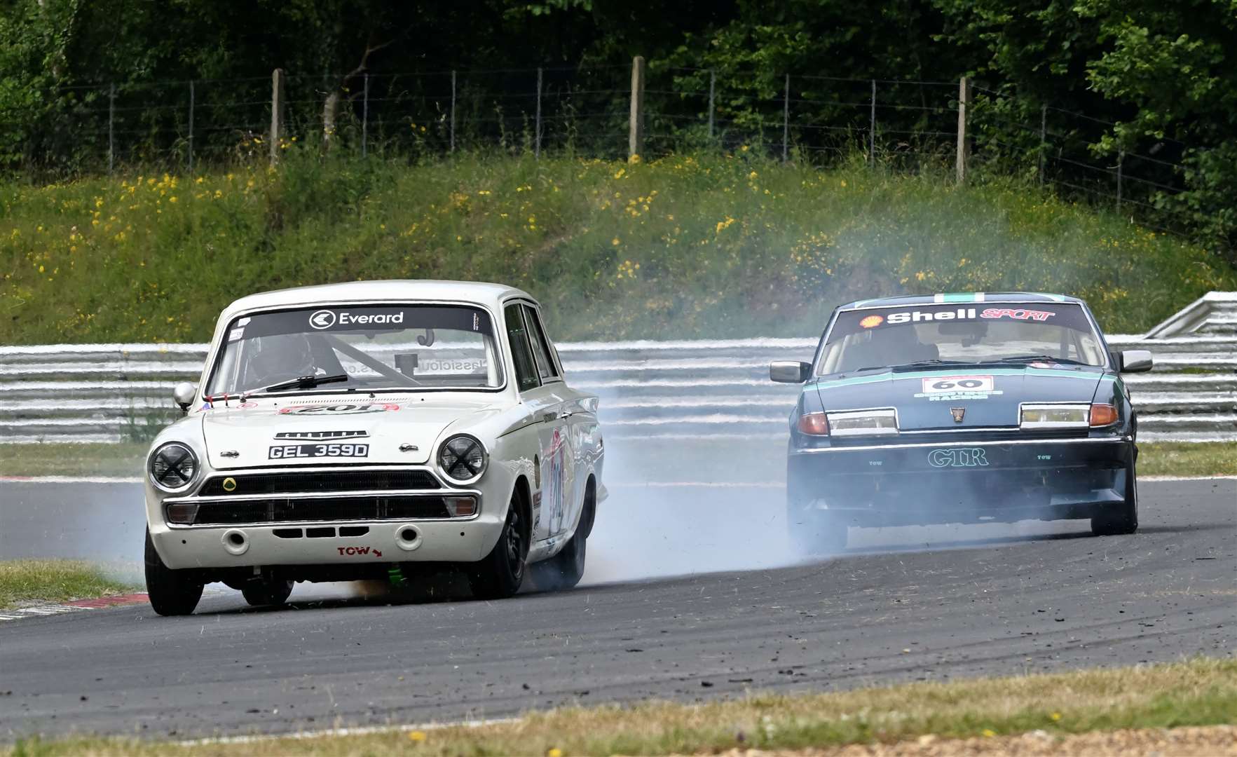 Pat Kenneally, from Sheerness, retired from the second Pre 66 race on Saturday in his Lotus Cortina, with smoke pouring from his engine. Picture: Simon Hildrew