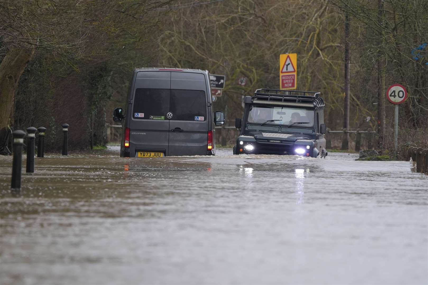 A car drives past a van stranded in floodwater in Yalding, Kent (Gareth Fuller/PA)