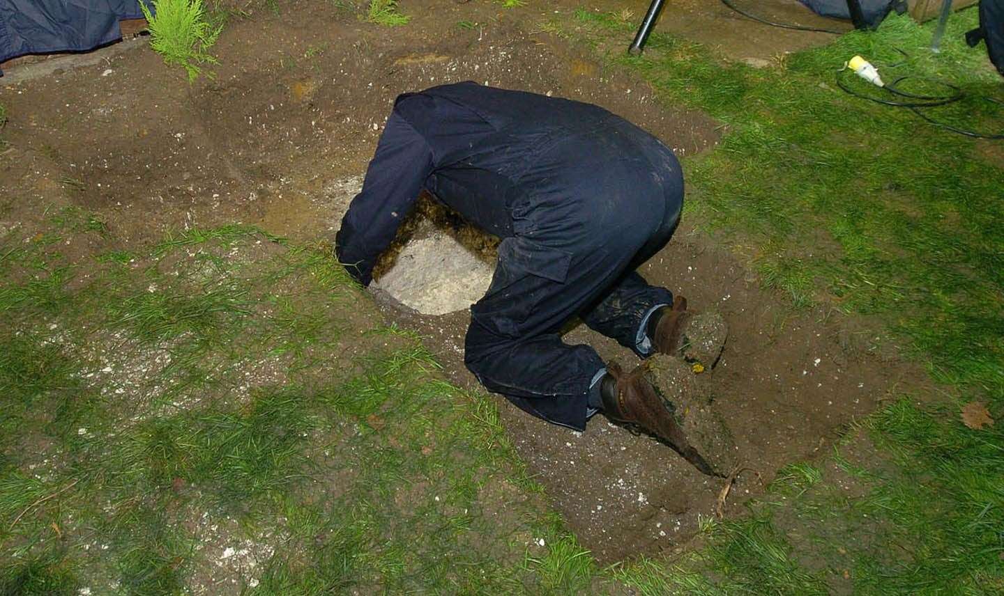 A hole dug in the back garden of property in Irvine Drive, Margate, where the bodies of the teenagers were found. Picture: Kent News and Pictures/pool Essex police