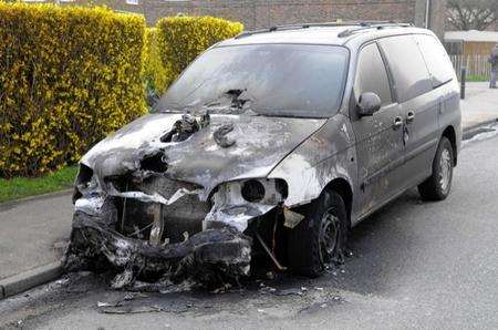 The remains of a burnt-out "W"-registration Kia Sedona, in St Georges Avenue, Sheerness