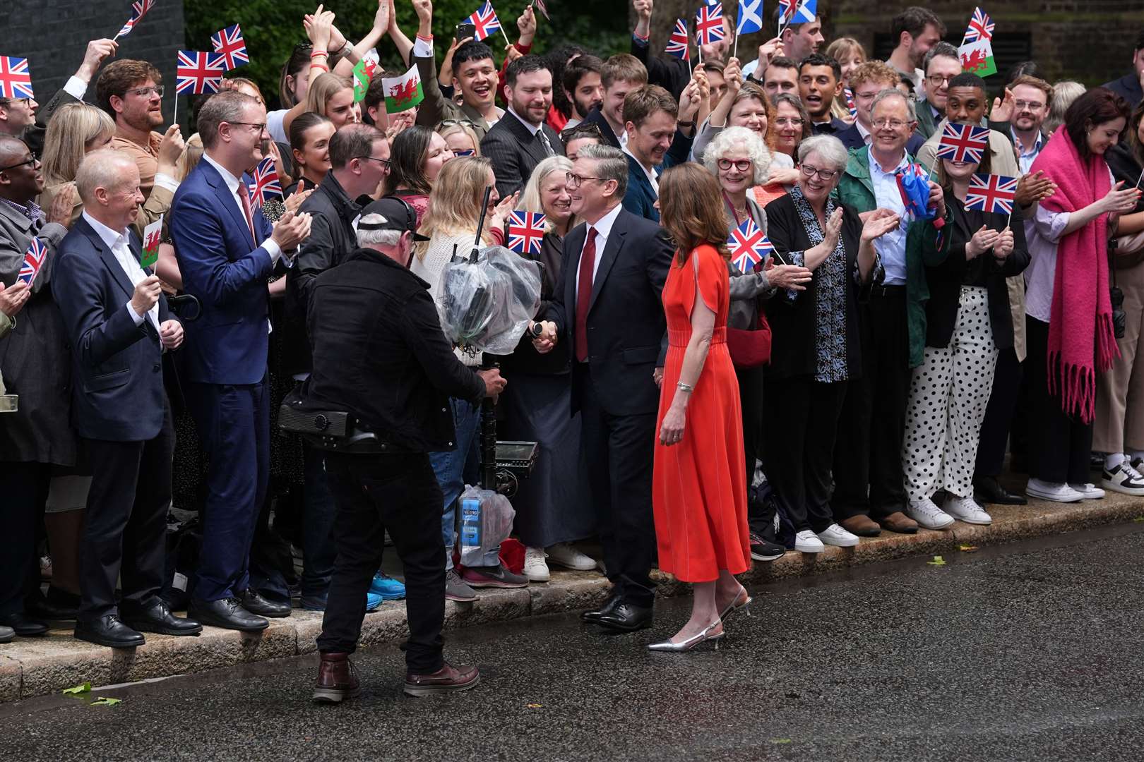 Sir Keir Starmer and his wife greet the crowds as he arrives at his official London residence at No 10 Downing Street for the first time (Gareth Fuller/PA)