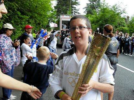 Jed Pearson enjoys his moment carrying the torch in East Grinstead