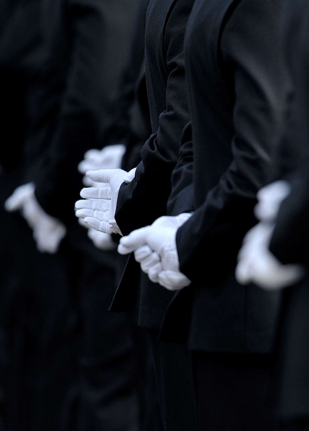 Metropolitan Police officers wearing white dress uniform gloves during a Metropolitan Police passing out parade for new officers at Peel House in Hendon (PA)