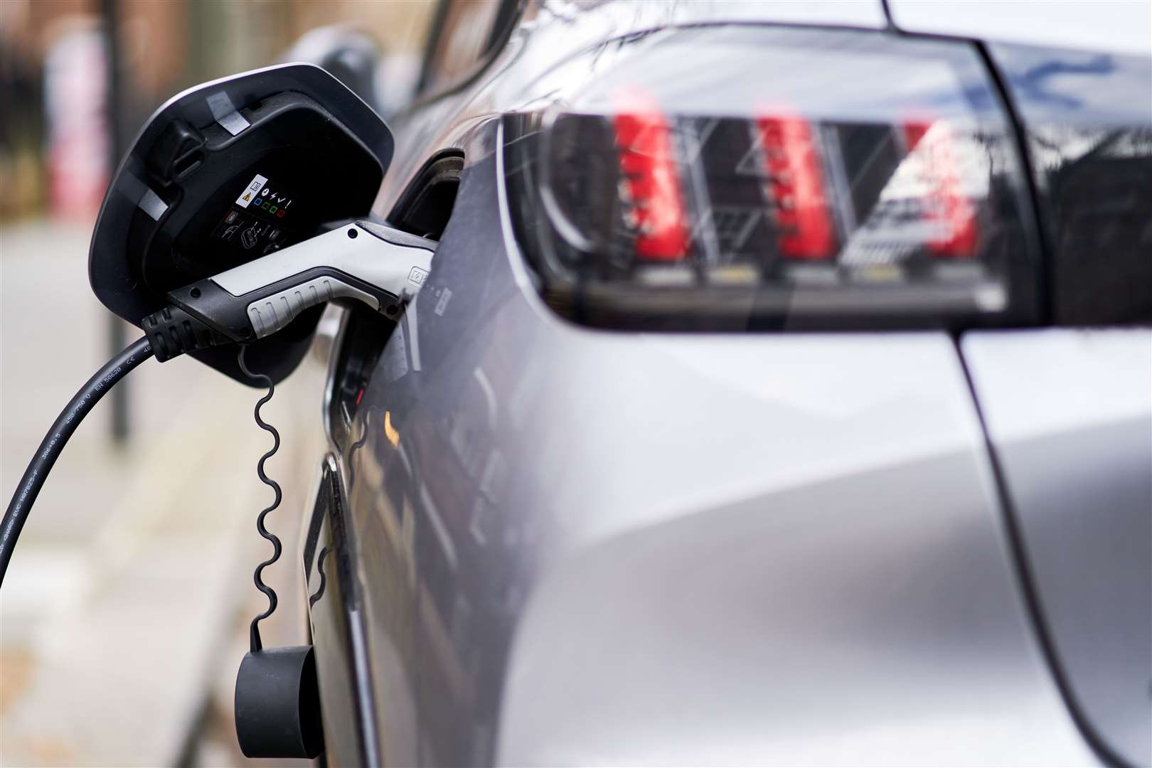 An electric car being charged (John Walton/PA)