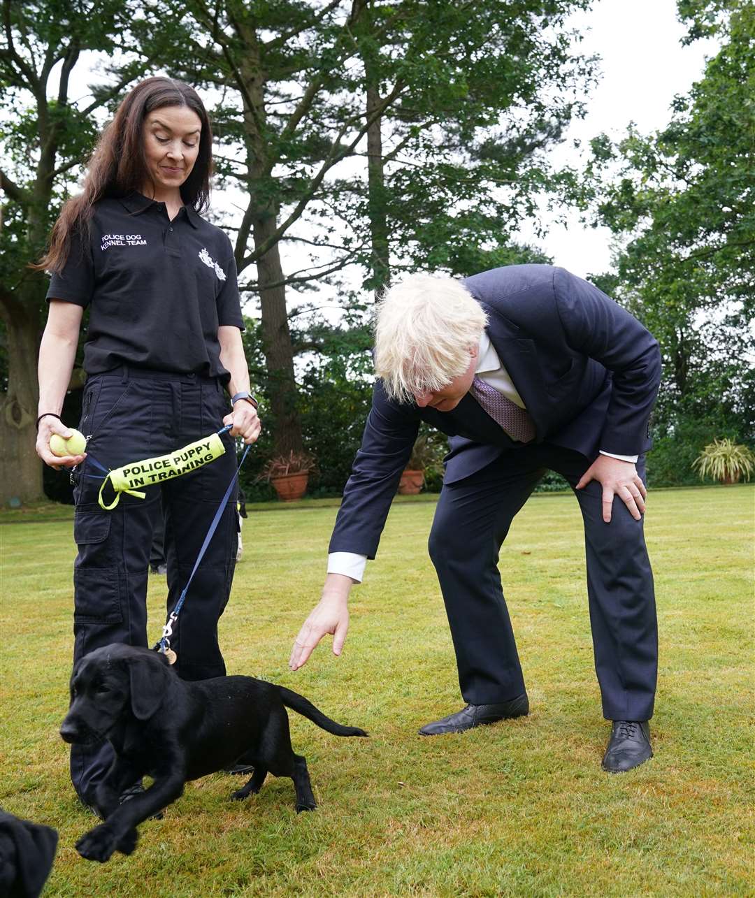 Prime Minister Boris Johnson speaks to police dog kennel staff during a visit to Surrey Police headquarters in Guildford, Surrey (Yui Mok/PA)