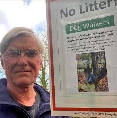 David Leekie with the sign he made urging dog owners to act responsibly