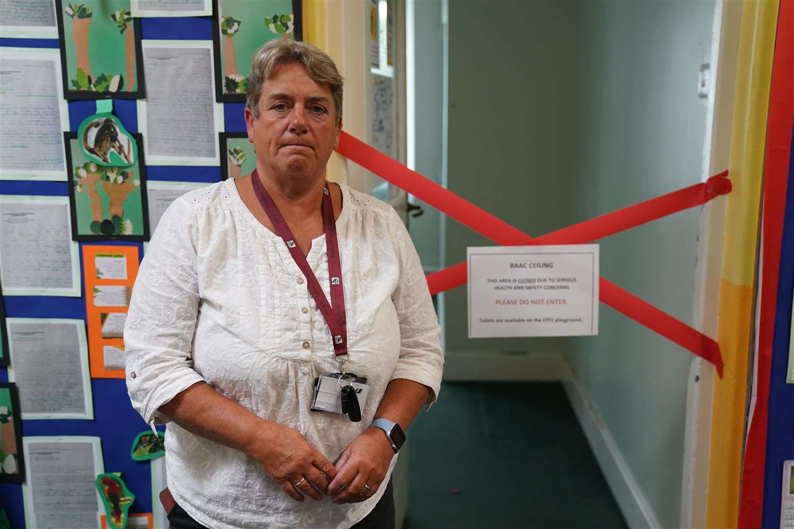 Caroline Evans stands next to a taped off section inside her school (Jacob King/PA)