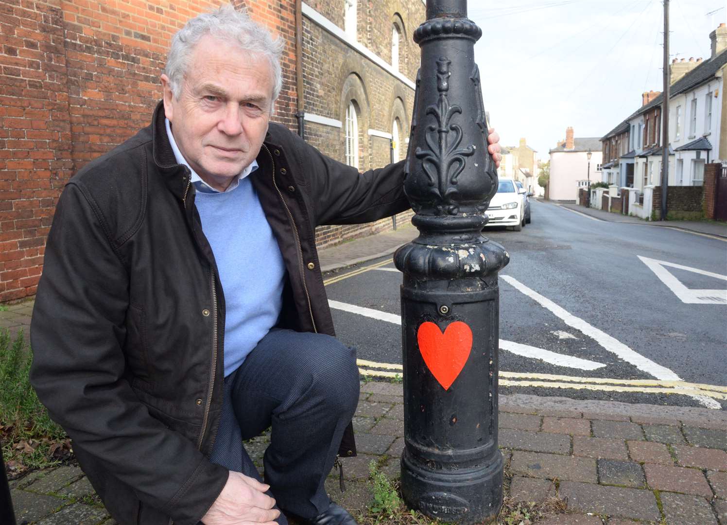 Cllr Stuart Tranter and the red heart posted on a pillar near his home in St Margaret's Street. Picture: Chris Davey