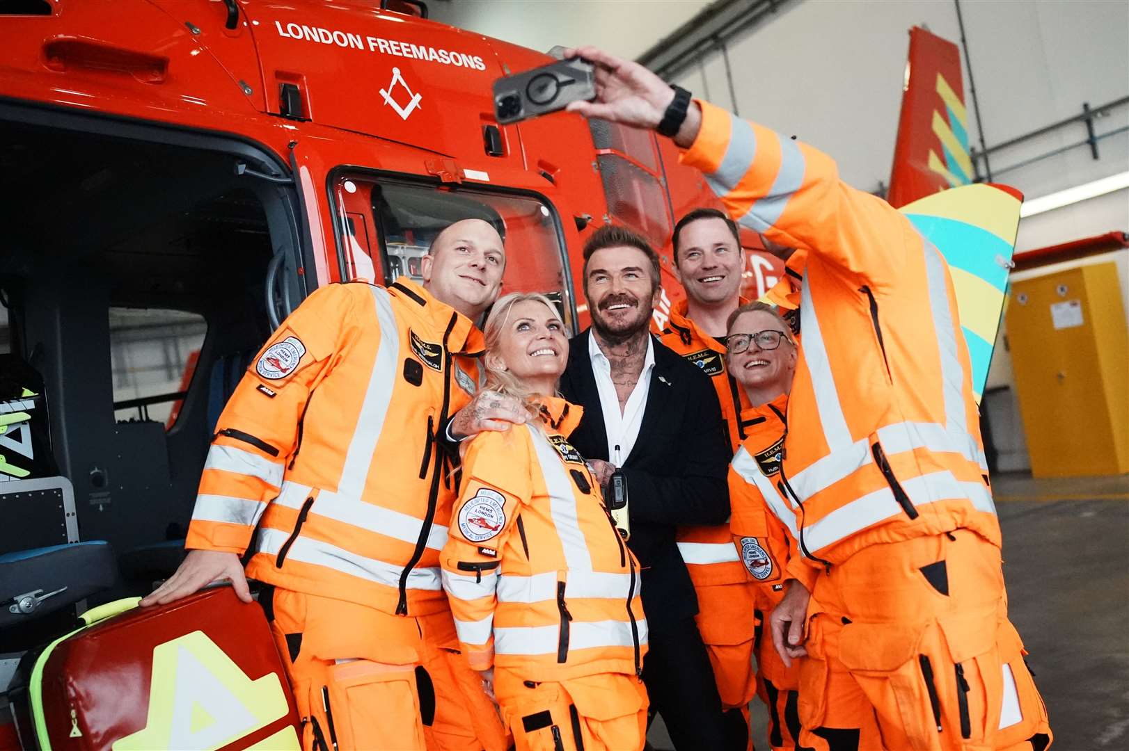 David Beckham poses for a selfie with members of the Air Ambulance crew during the visit (Aaron Chown/PA)