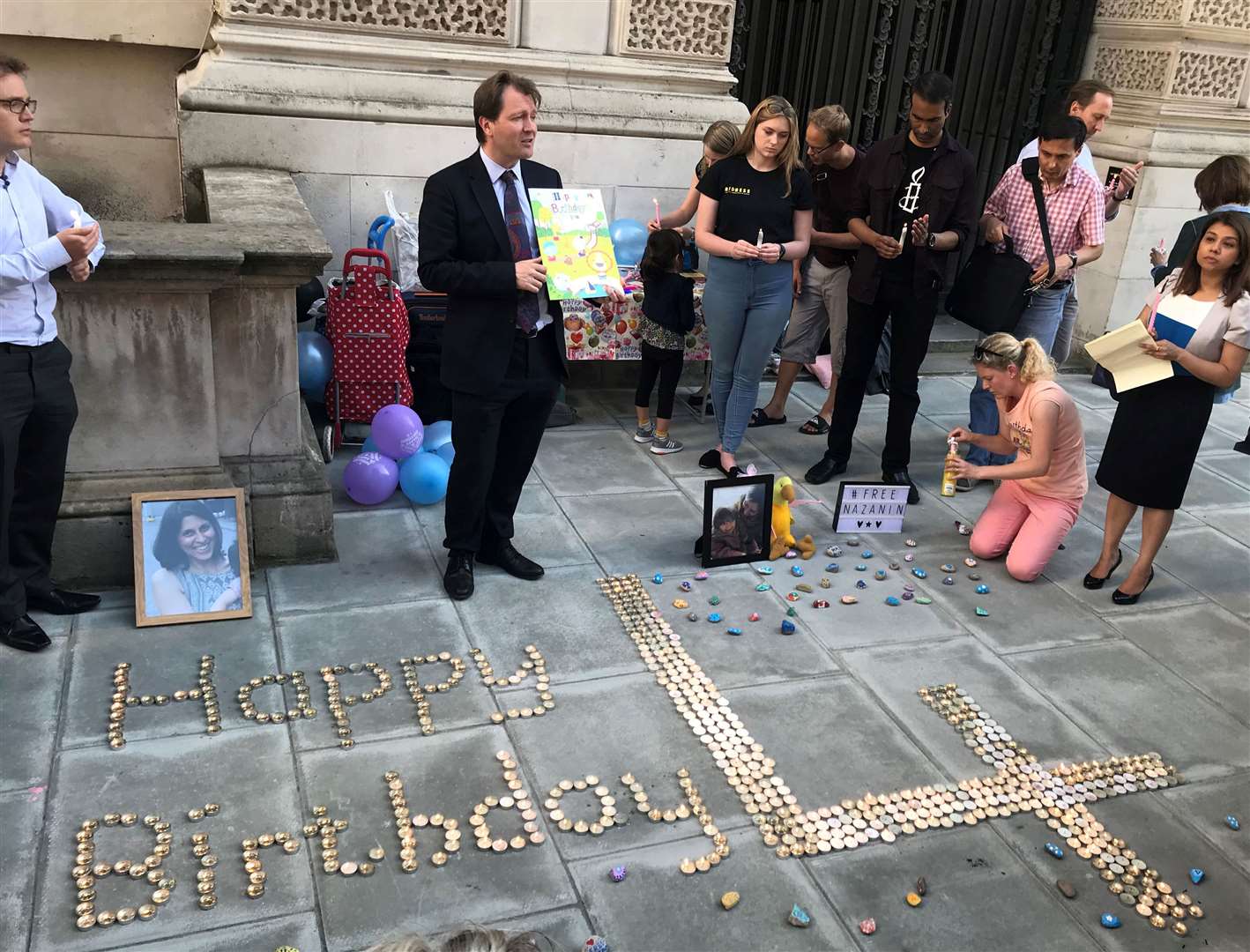 Campaigners spell out birthday messages outside the Iranian Embassy (Kathryn Younger/PA)