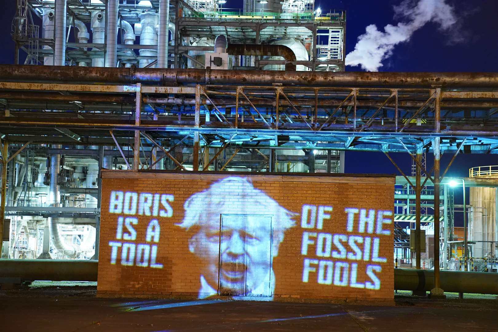 A projection at the Grangemouth Oil Refinery in Falkirk, by climate activists from Ocean Rebellion, during Cop26