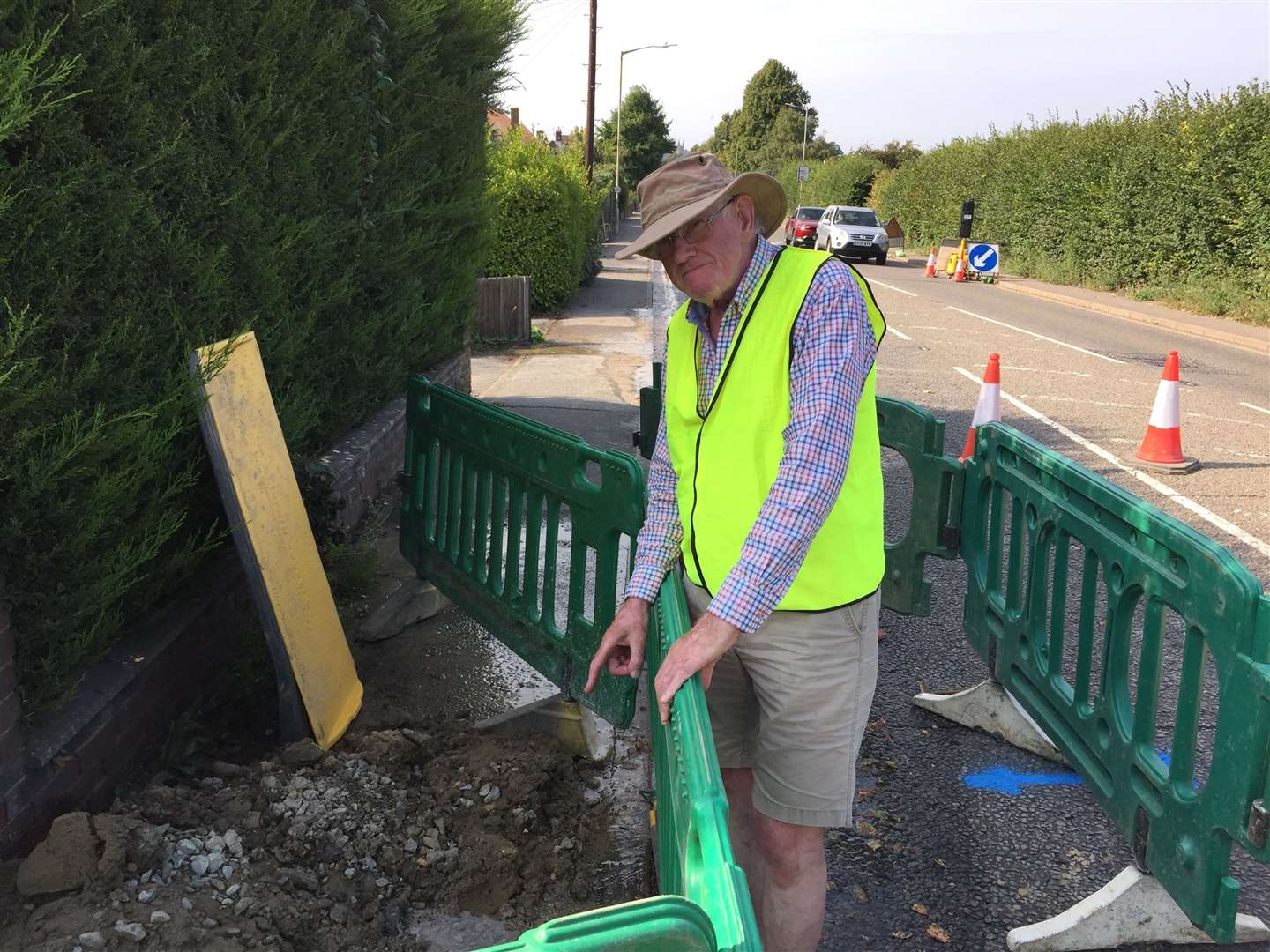 New Dover Road resident Tom Lynch at the site of the water leak