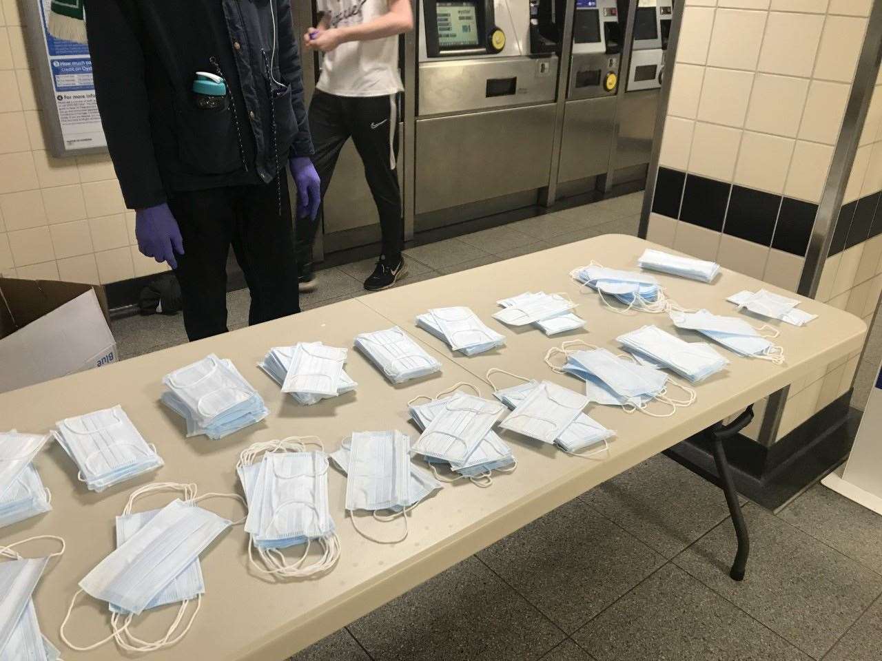 Face coverings being handed out to passengers at Vauxhall Underground station in London (Emma Bowden/PA)