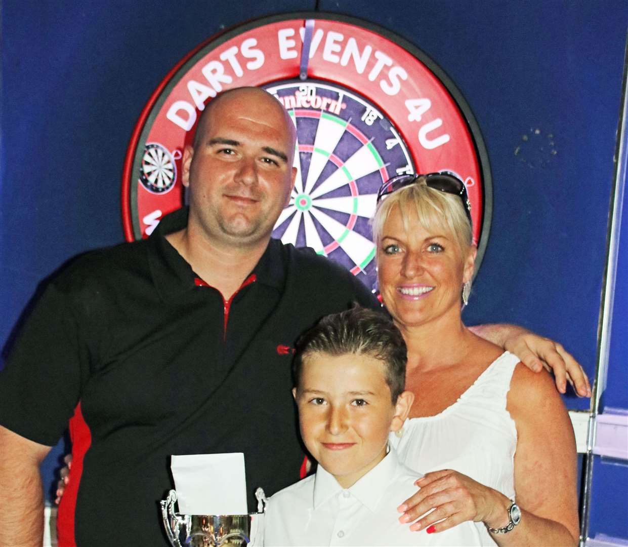 Rob Cross, left, pictured with Merlins Entertainment's Lee Dunn and her nephew Gary after winning the Sheppey Darts Classic in June 2017. Picture: Tony Cox