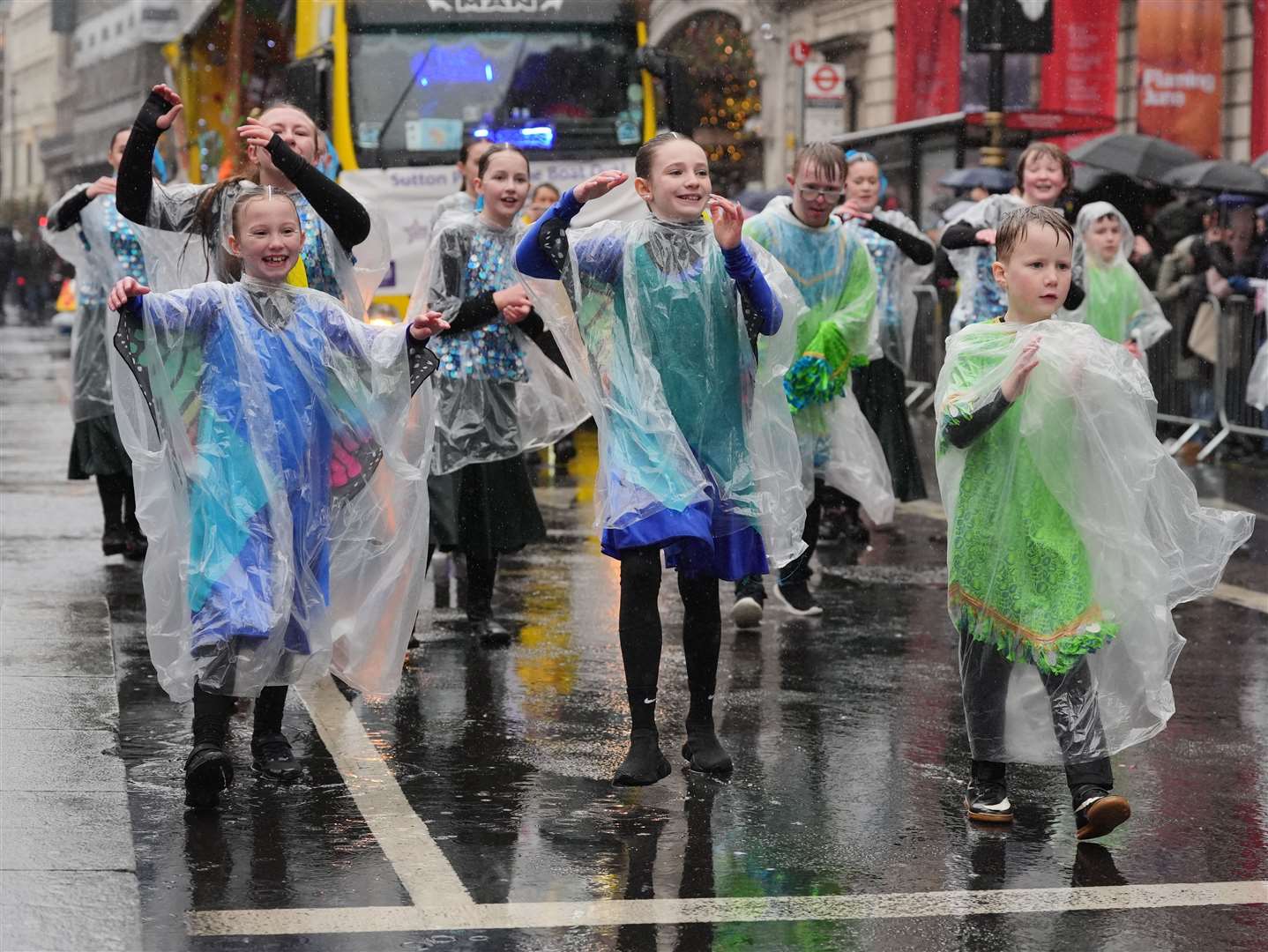 Performers didn’t let the rain dampen spirits as they danced in the New Year’s Day parade (Jonathan Brady/PA)