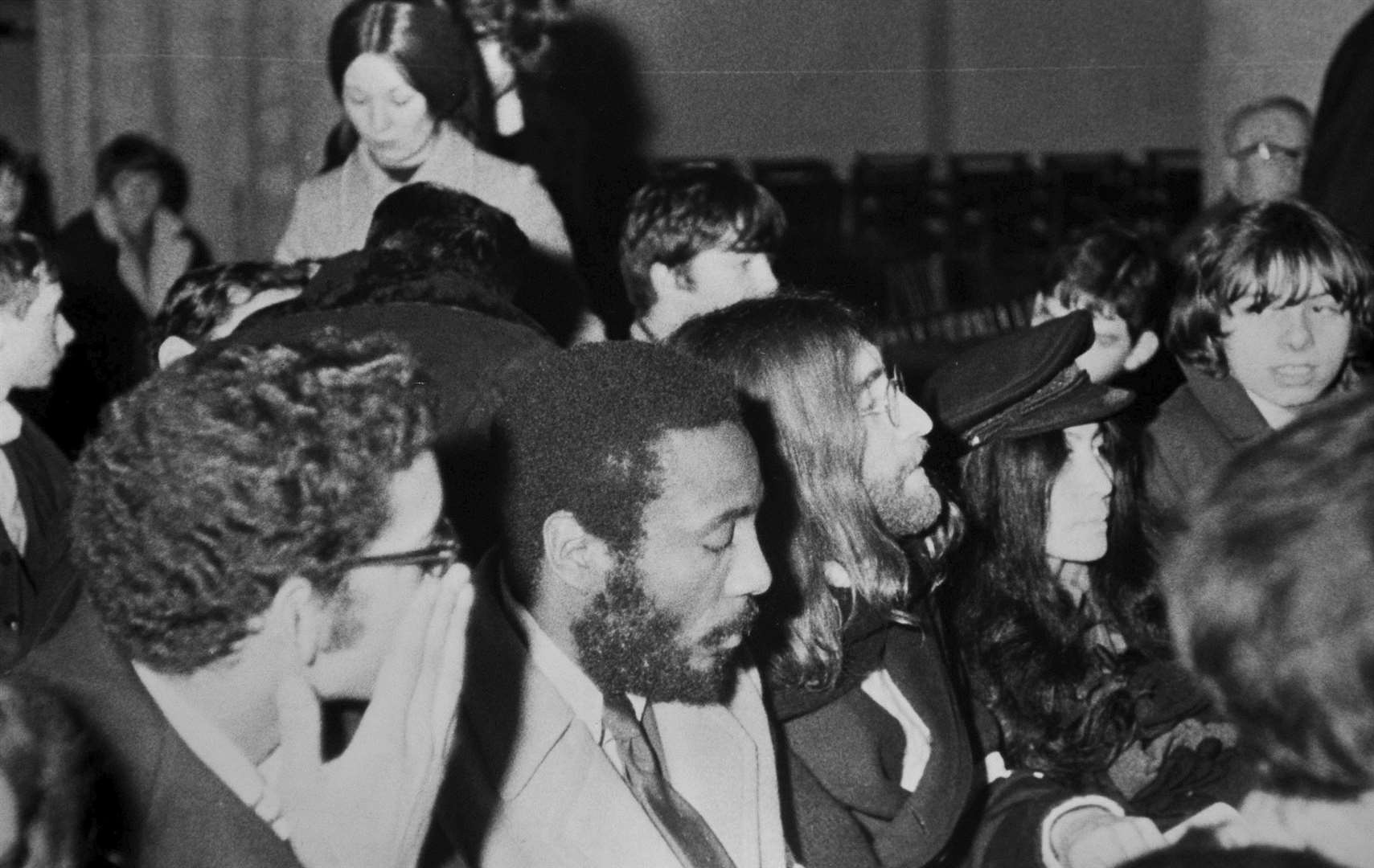 John Lennon and Yoko Ono at midnight mass in Rochester Cathedral in 1969. With them is the American comedian Dick Gregory