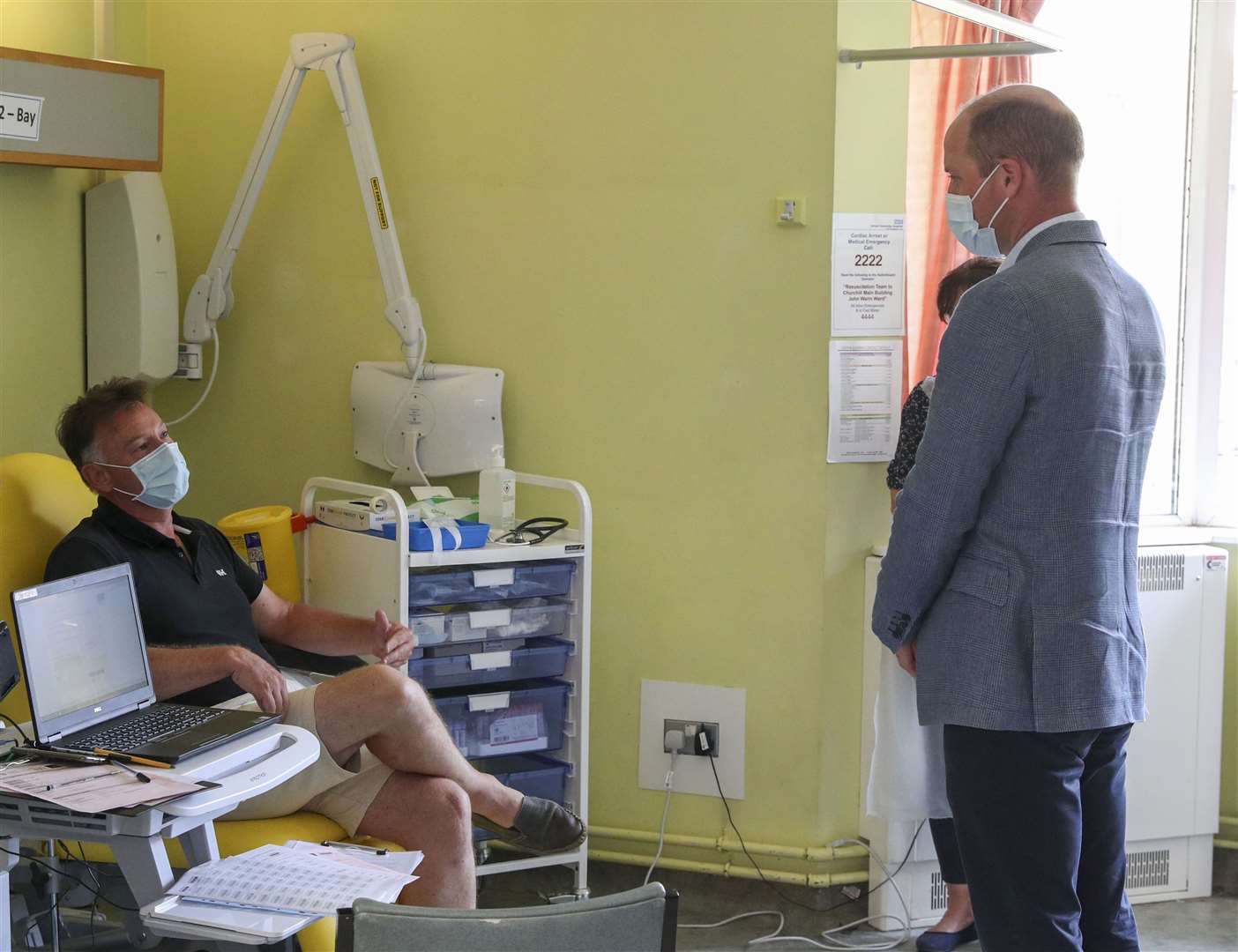 The Duke of Cambridge talks to a patient participating in the Covid-19 vaccine trial last year (Steve Parsons/PA)