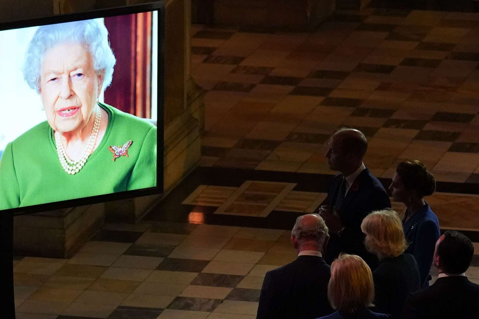 The Prince of Wales and the Duchess of Cornwall watching as the Queen makes a video message (Alberto Pezzali/PA)