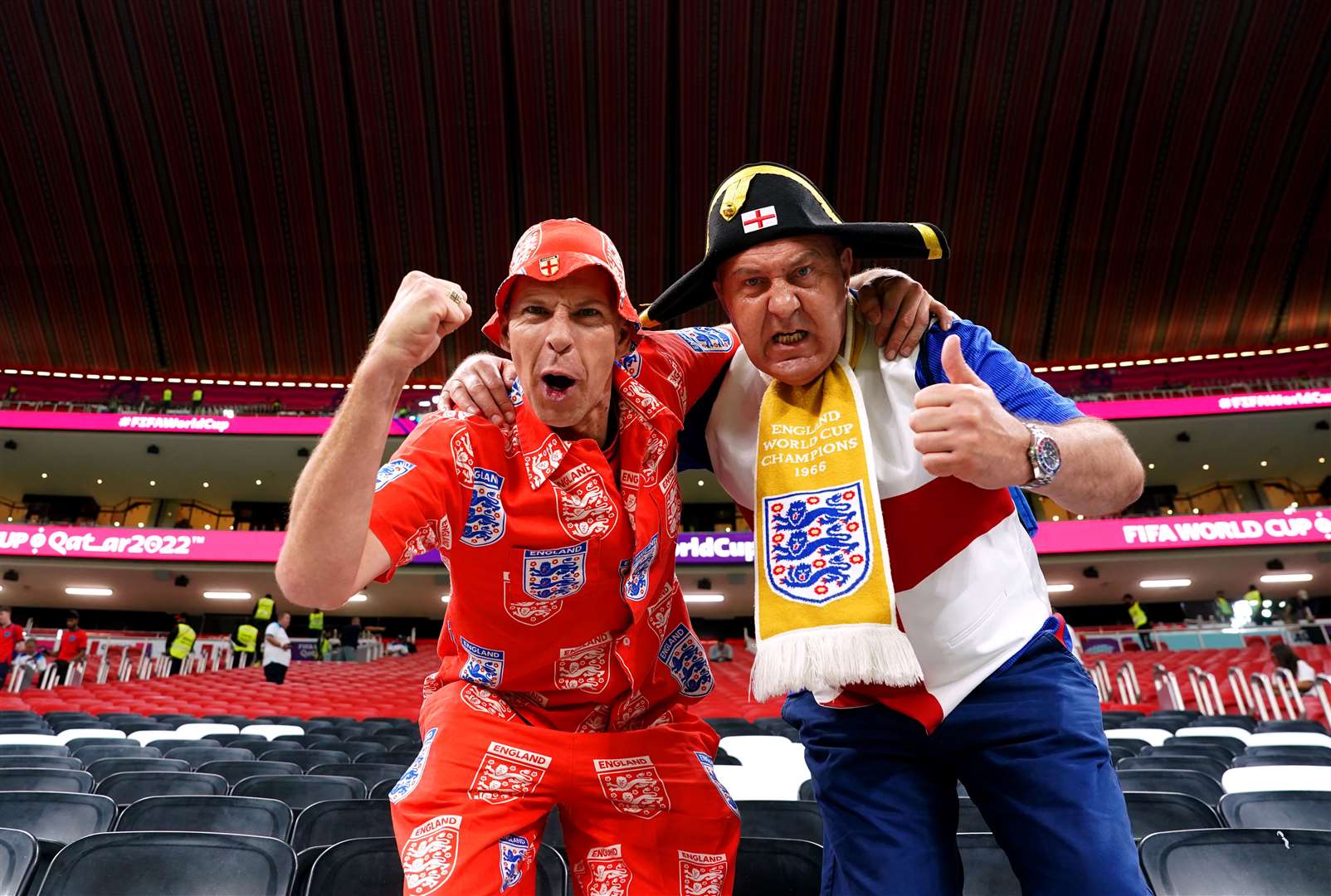 England fans Mark Trigg (left) and Garford Beck in the stands at the Al-Bayt Stadium in Al Khor, Qatar (Martin Rickett/PA)