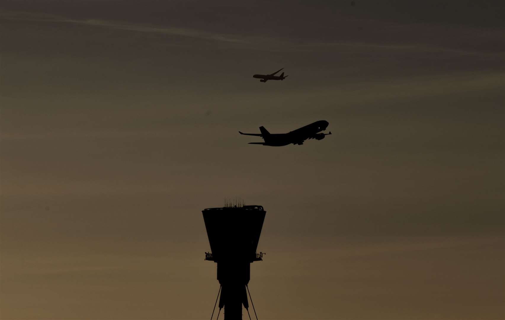 A plane takes off past the control tower at Heathrow Airport (Steve Parsons/PA)