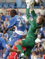 Guylain Ndumbu-Nsungu is beaten in the air by Cheltenham keeper Scott Brown. Picture: GRANT FALVEY