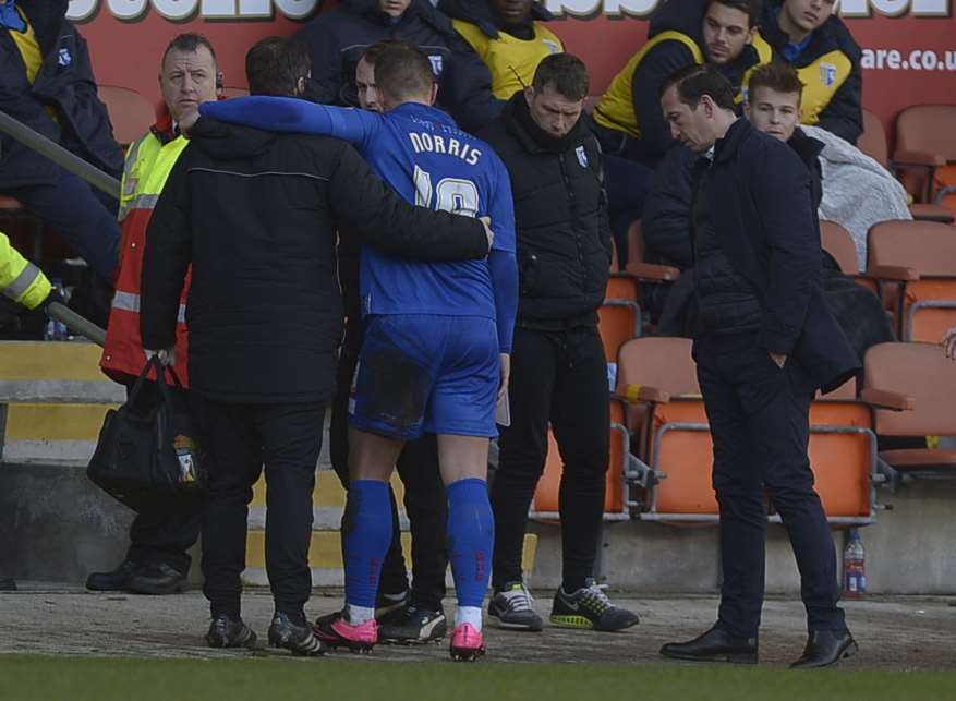 Luke Norris is helped off at Blackpool as boss Justin Edinburgh looks on Picture: Barry Goodwin