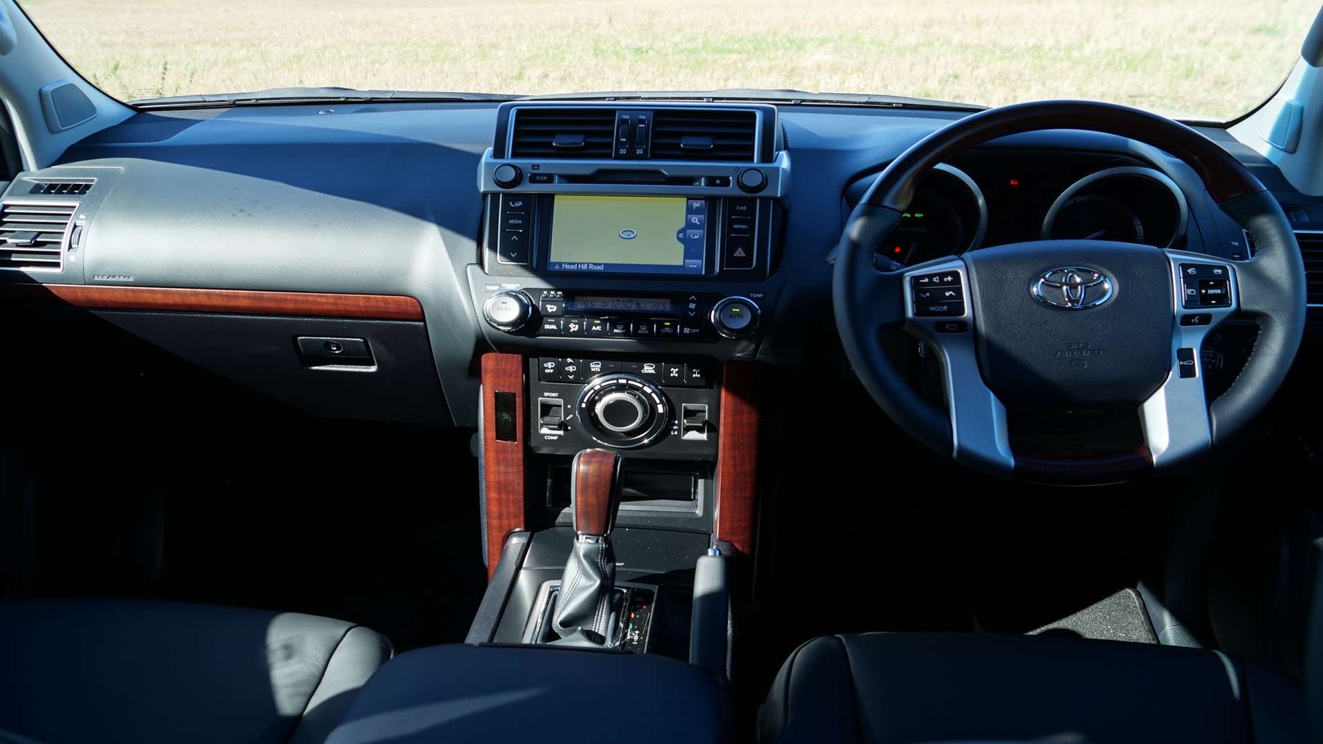 Wood trim on the dash and steering wheel gives the cabin a certain old world charm