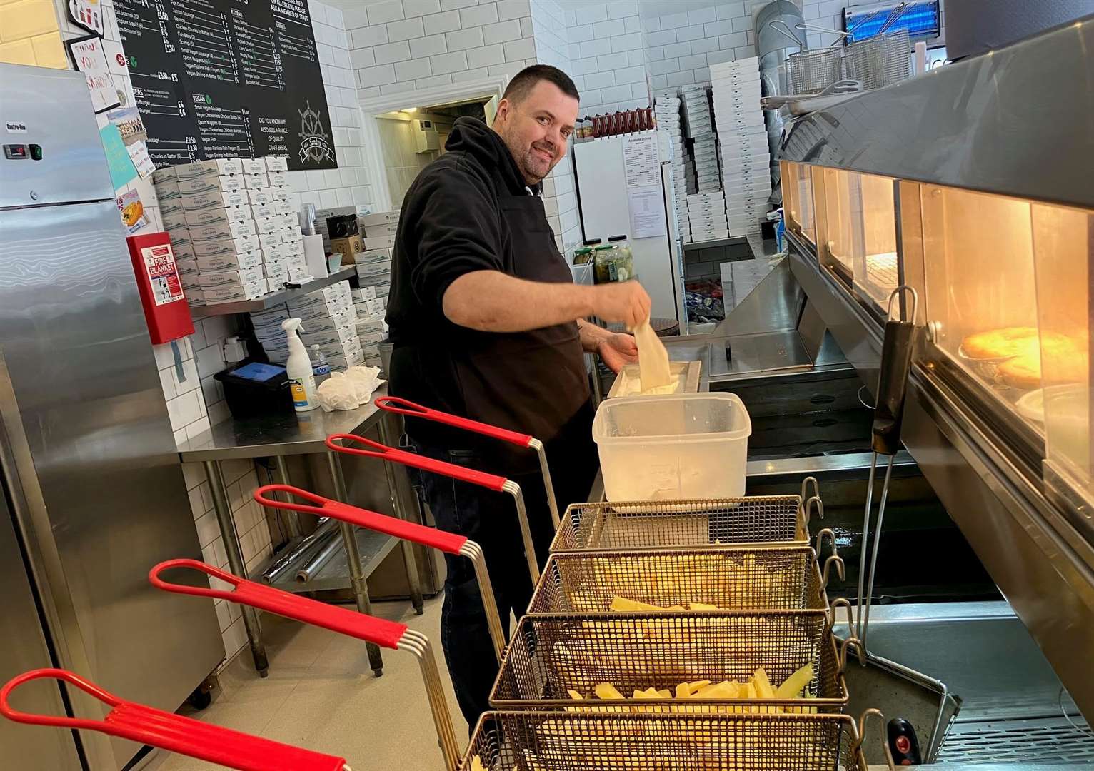 Andy Burnett at work battering cod in his Folkestone shop. Photo: KMG/LDRS