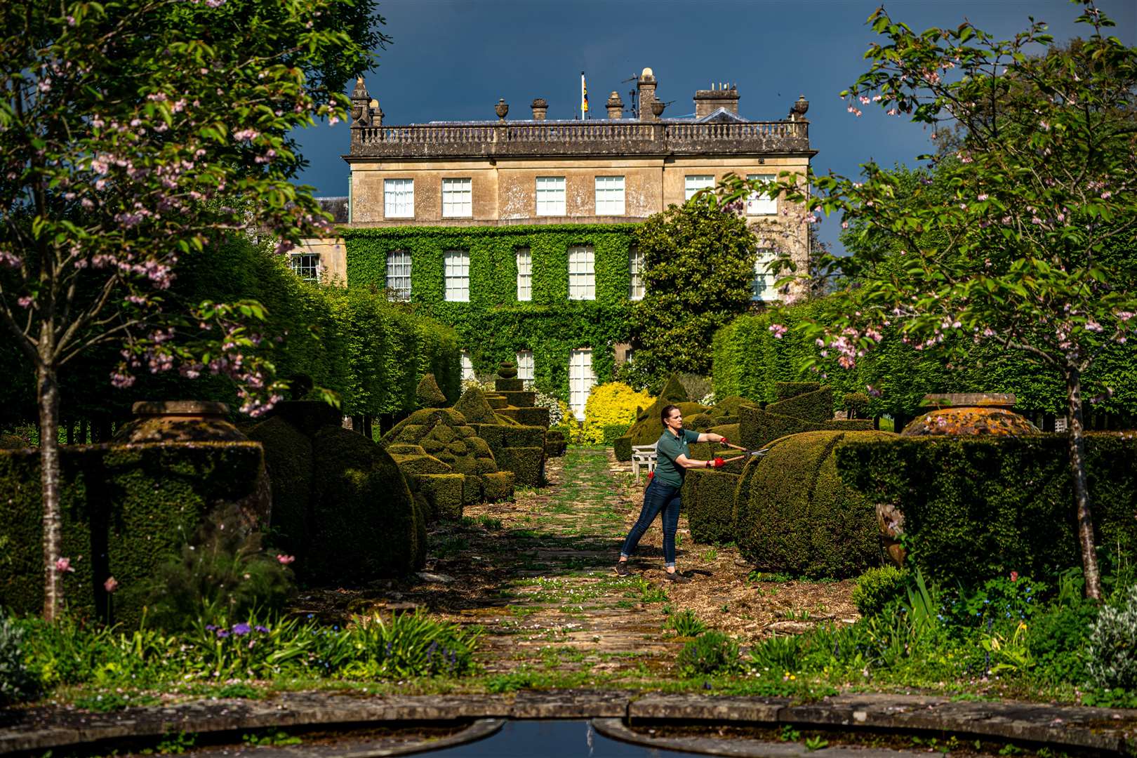 A gardener tends to topiary bushes in the gardens of Highgrove in Gloucestershire (Ben Birchall/PA)